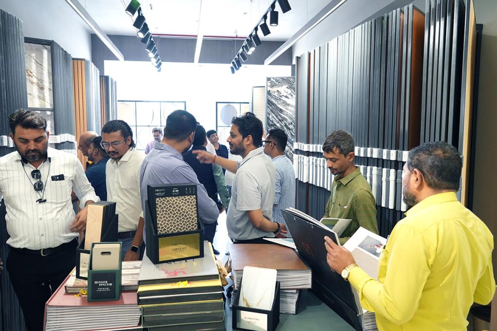 Visitors exploring Honest’s laminate and acrylic catalogue